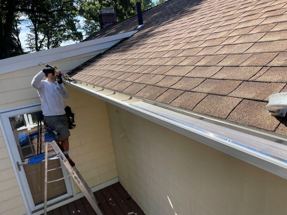 Boston Gutter Solutions team during gutter guards installation